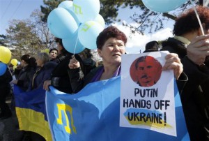 Participants hold placards and shout slogans during an anti-war rally in the Crimean town of Bakhchisaray