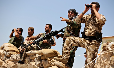 Kurdish peshmerga fighters take position in Bashiqa, near Mosul.