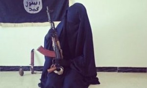 A female ISIS recruit poses with an AK-47.  (Source: The Guardian)