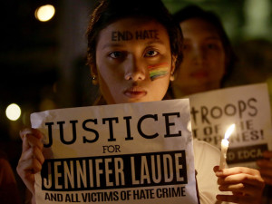 Protestors light candles and demand justice in the murder of Filipino transgender woman Jennifer Laude. (AP Photo/Bullit Marquez)