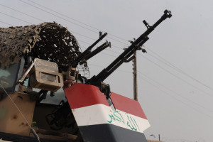 An Iraqi soldier of the 9th Iraqi Army Division (Mechanized) pulls security from his turret outside of an election site in Solmon Pak, Iraq, Jan. 30, 2009.   (U.S. Army photo by Spc. Chase Kincaid/Released)
