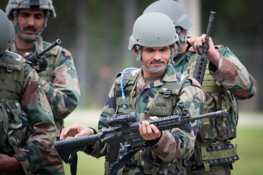 An_Indian_Army_paratrooper_with_the_50th_Independent_Para_Brigade_examines_an_M4_carbine_prior_to_sighting_in_the_weapon_at_Fort_Bragg,_N.C.